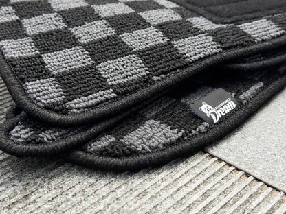 Nissan Skyline GTR R34 BNR34 GTT checker floor mats stacked corner detail with Dream Performance label