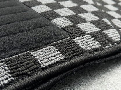 Reinforced black heel pad on Nissan Skyline R34 BNR34 checker floor mat driver side