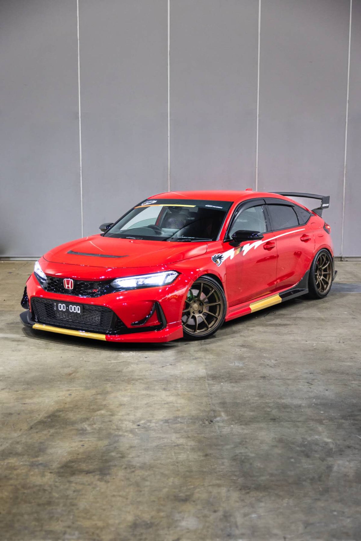 Front three quarter view of a red Honda Civic Type R FL5 fitted with the Mugen style side graphic decal