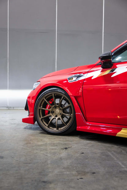 Front guard detail of a red FL5 Civic Type R showing where the winged eye graphic sits above the wheel arch