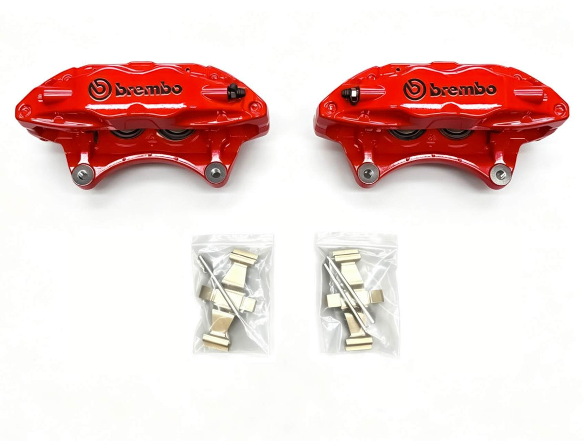 Red Brembo F50 caliper pair laid flat with anti rattle clips and retaining pins