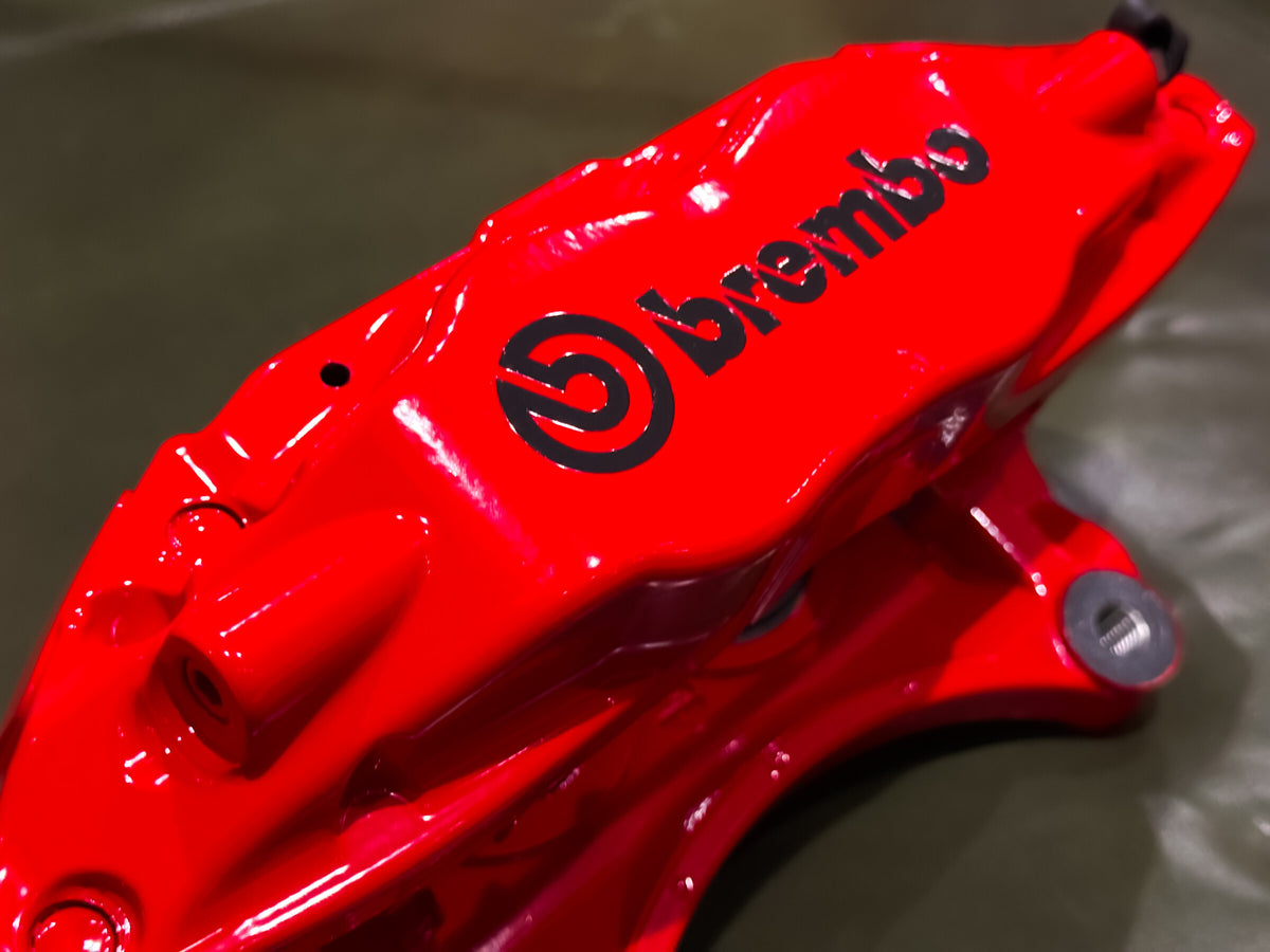 Three quarter view of a red Brembo F50 caliper for Subaru WRX and STI