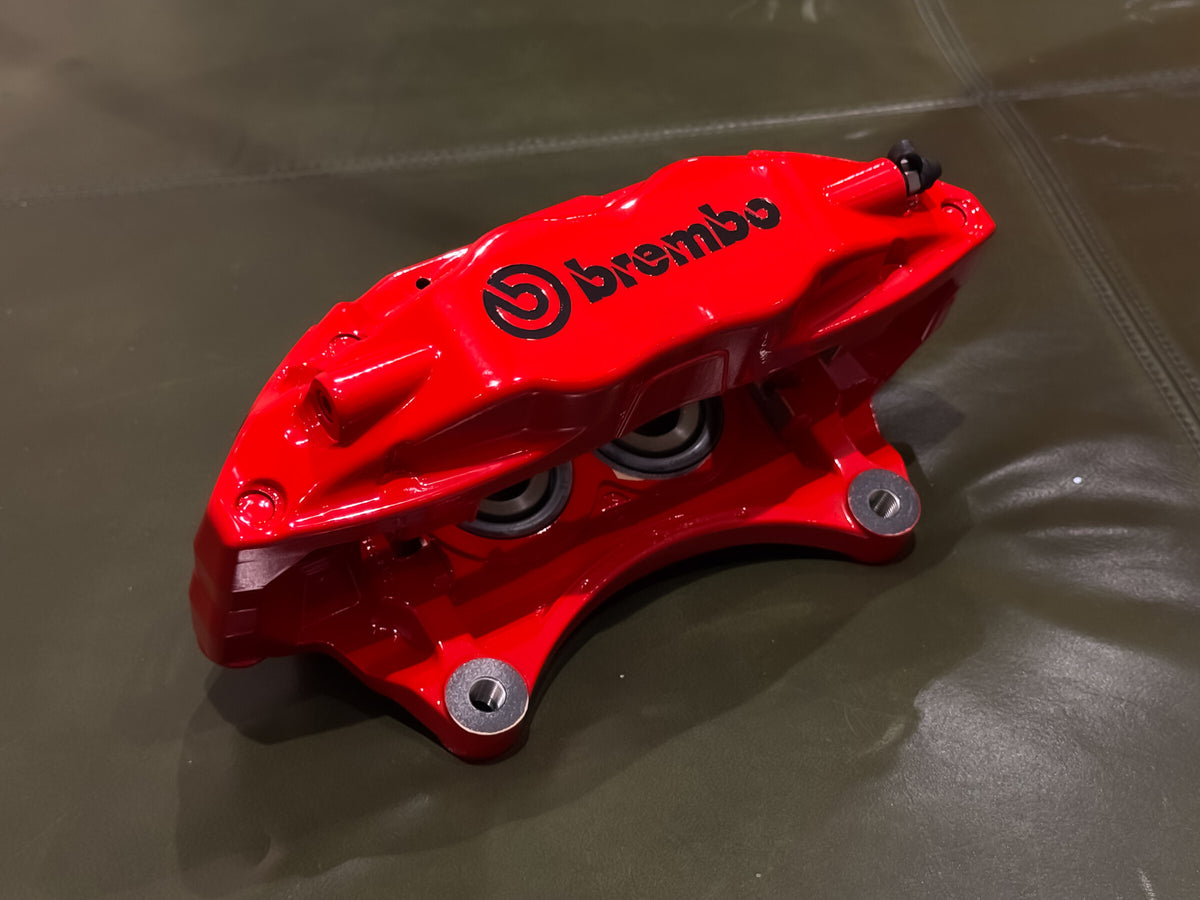 Red Brembo F50 caliper profile showing the bridge and mounting ears