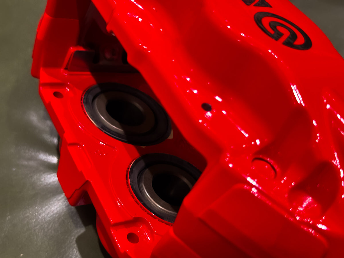 Piston bores inside a red Brembo F50 four piston caliper