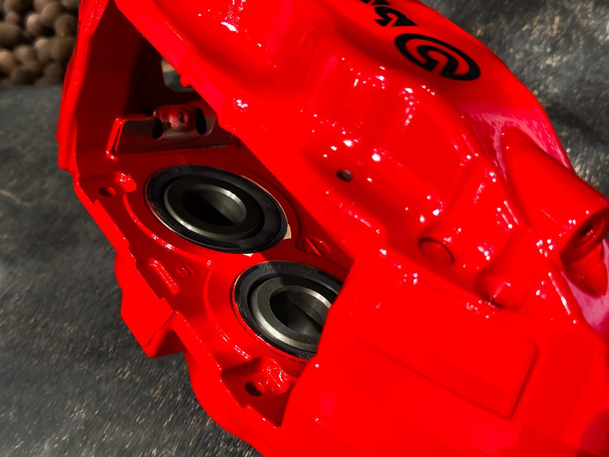 Close up of the four piston bores and dust seals on the red F50 caliper