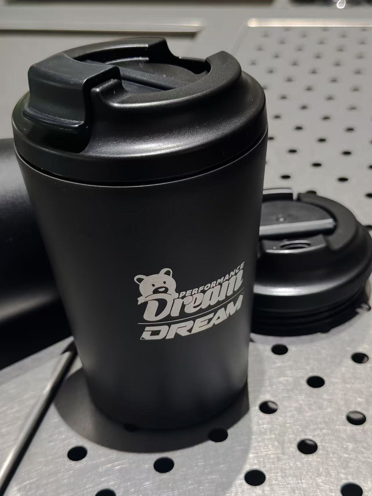 Dream Performance x Fressko coffee cup close up of engraved logo and lid