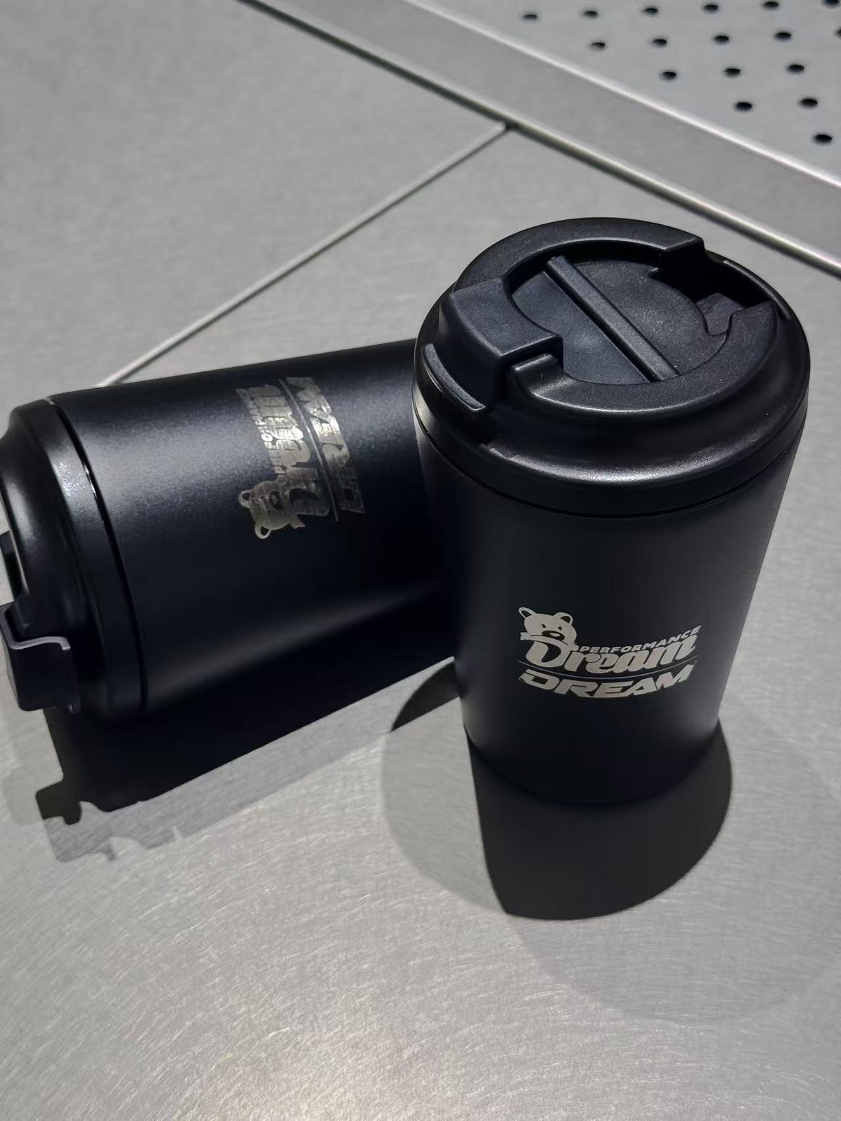Dream Performance x Fressko coffee cup with lid beside the cup