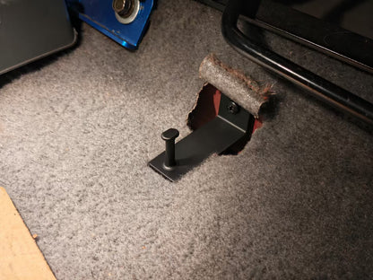 Floor mat hook installed on the floor of a Honda Civic, side view
