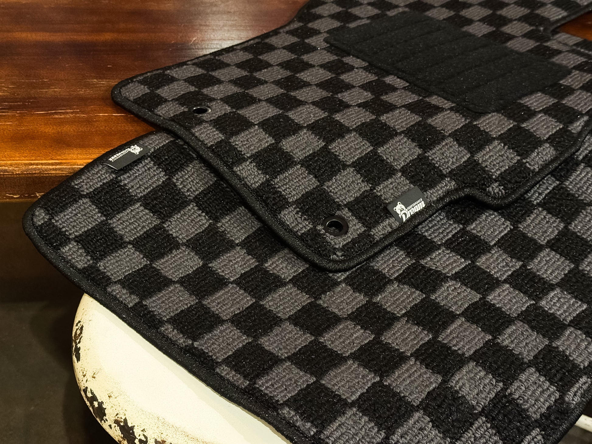 Grey and black checker floor mats with bound edge and factory fixing eyelet