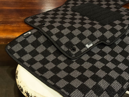 Grey and black checker floor mats with bound edge and factory fixing eyelet