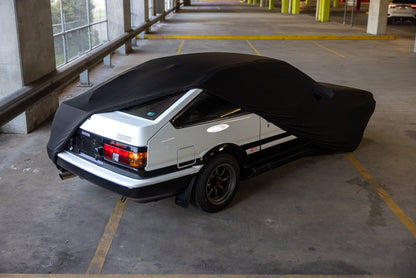 AE86 Sprinter Trueno hatch with the indoor car cover partly fitted, rear view